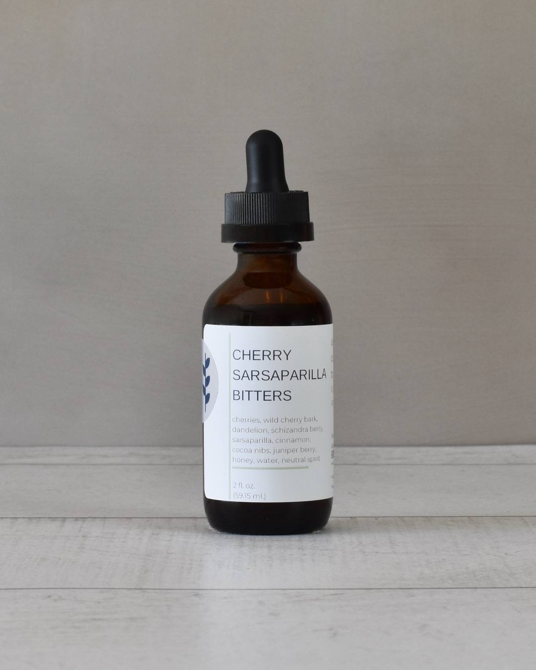 FreeWildShe Cherry Sarsaparilla Bitters sit on a white countertop.