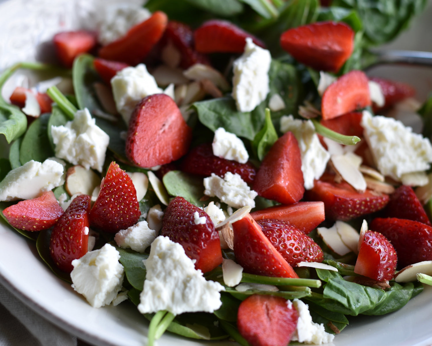 A fresh summer spinach salad with strawberries, feta, almonds and a playful Strawberry Hibiscus Bitters dressing. A curious bitters recipe beyond drinks.