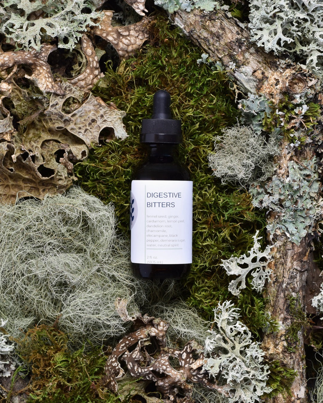 FreeWildShe Digestive Bitters sit on moss & lichen.