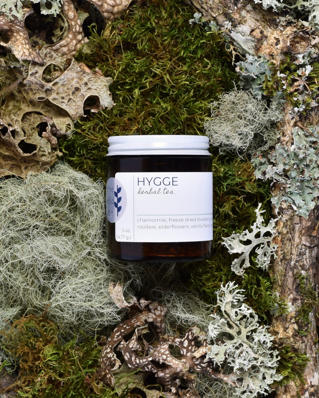 FreeWildShe Hygge Herbal Tea 20 servings sits on moss & lichen.