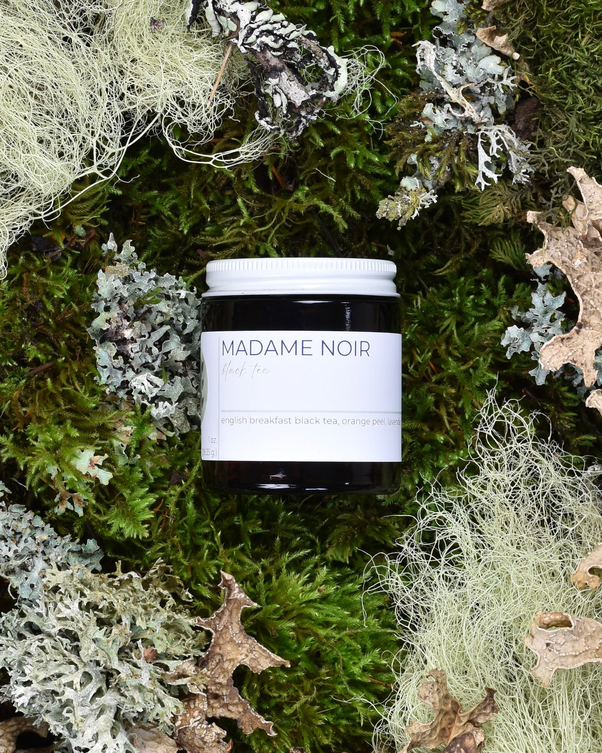 FreeWildShe Madame Noir Black Tea 20 servings sits on moss & lichen.