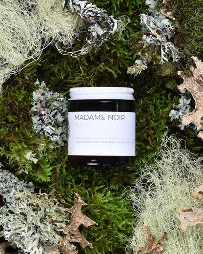 FreeWildShe Madame Noir Black Tea 20 servings sits on moss & lichen.